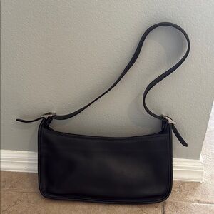 Coach black leather short strap bag. Hangs at waste.